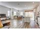 Open-concept living area with hardwood floors, dining area, and kitchen with stainless steel appliances at 762 Lilac Oak St, Henderson, NV 89011