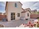 Backyard featuring stone-paved patio and sliding glass doors into the home at 7664 Mallard Bay Ave, Las Vegas, NV 89179