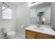 Bright bathroom with vanity, mirror, toilet, and window at 8646 Mesquite Hills St, Las Vegas, NV 89139