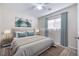 Staged bedroom with neutral walls, a plush bed, and natural light from the window at 8646 Mesquite Hills St, Las Vegas, NV 89139