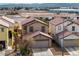 Two-story home featuring a tan exterior, brown roof and an attached two-car garage at 8646 Mesquite Hills St, Las Vegas, NV 89139