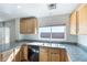 Bright kitchen featuring wood cabinetry, granite countertops, and stainless steel sink at 8646 Mesquite Hills St, Las Vegas, NV 89139