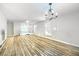 Bright living room with wood floors, lots of windows and a modern chandelier at 8646 Mesquite Hills St, Las Vegas, NV 89139