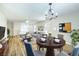 Open-concept living and dining area featuring a ceiling fan and wood-look floors at 8646 Mesquite Hills St, Las Vegas, NV 89139