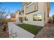 This backyard has a strip of artificial turf, a walkway, and access to the home's outdoor areas at 88 Pristine Glen St, Las Vegas, NV 89135