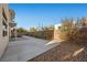 This backyard boasts a walkway, landscaping, and a gravel area, enclosed with a brick wall at 88 Pristine Glen St, Las Vegas, NV 89135