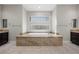 Luxurious bathroom featuring a soaking tub with a granite surround and dual vanities at 88 Pristine Glen St, Las Vegas, NV 89135