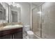 This bathroom features a tile shower with a glass door, granite counters, and updated cabinets at 88 Pristine Glen St, Las Vegas, NV 89135