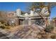 Modern two-story home featuring a brick driveway, grey exterior paint, and a well-manicured front yard at 88 Pristine Glen St, Las Vegas, NV 89135
