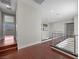 Hallway featuring wood floors, metal railings, and access to the second floor at 88 Pristine Glen St, Las Vegas, NV 89135