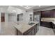 Modern kitchen showcasing a large granite island, stainless steel appliances, and open layout at 88 Pristine Glen St, Las Vegas, NV 89135