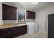 This laundry room boasts ample cabinet space, granite countertops, and modern appliances at 88 Pristine Glen St, Las Vegas, NV 89135
