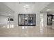 Open concept living area with high ceilings, tile flooring, and expansive sliding glass doors at 88 Pristine Glen St, Las Vegas, NV 89135