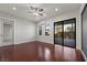 Bright living room with hardwood floors, ceiling fan, and access to the patio at 88 Pristine Glen St, Las Vegas, NV 89135