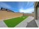 This backyard features a small lawn, a brick perimeter and a concrete paver patio at 8866 Mountain Lion Ave, Las Vegas, NV 89166