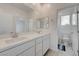 Bright bathroom with double vanity, large mirror, and separate toilet room at 8866 Mountain Lion Ave, Las Vegas, NV 89166