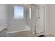 Modern bathroom boasting a soaking tub, shower with glass enclosure, and bright white finishes at 8866 Mountain Lion Ave, Las Vegas, NV 89166