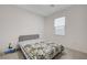 Simple bedroom with neutral carpet, window, and a patterned duvet cover at 8866 Mountain Lion Ave, Las Vegas, NV 89166