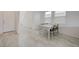 Bright dining area featuring wood-look floors, a table with chairs, and natural light from two windows at 8866 Mountain Lion Ave, Las Vegas, NV 89166