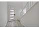 Bright entryway featuring wood-look floors, a modern front door with glass panels, and a staircase at 8866 Mountain Lion Ave, Las Vegas, NV 89166