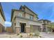 Modern two-story home with stone accents, desert landscaping, and a brick-paved driveway leading to the garage at 8866 Mountain Lion Ave, Las Vegas, NV 89166