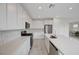 Bright, open kitchen features white cabinets, stainless steel appliances, and a large island with counter seating at 8866 Mountain Lion Ave, Las Vegas, NV 89166