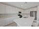 Well-lit kitchen with white cabinetry, stainless steel appliances, quartz countertops, and a spacious island at 8866 Mountain Lion Ave, Las Vegas, NV 89166