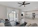 Open-concept living area with gray sofa, sliding glass doors to the backyard, and a view into the kitchen at 8866 Mountain Lion Ave, Las Vegas, NV 89166
