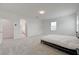 Bright main bedroom featuring soft carpet, ensuite bathroom, and neutral walls and trim at 8866 Mountain Lion Ave, Las Vegas, NV 89166