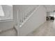 Bright staircase area featuring carpeted steps and wood-look floors leading to a dining and living space at 8866 Mountain Lion Ave, Las Vegas, NV 89166