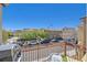 A view from the balcony looking over the neighborhood, featuring cars and rooftops on a sunny day at 8868 Intertwine, Las Vegas, NV 89149