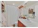 Well-lit bathroom with vanity, shower and bath with curtain at 8868 Intertwine, Las Vegas, NV 89149