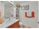 Cozy bathroom with a large mirror and an orange-themed decor and tile flooring at 8868 Intertwine, Las Vegas, NV 89149