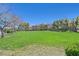 Lush green community park with mature trees and shaded picnic area, offering a peaceful outdoor setting at 8868 Intertwine, Las Vegas, NV 89149