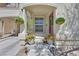 Inviting front porch with decorative plants, stylish door, and modern outdoor lighting at 8868 Intertwine, Las Vegas, NV 89149