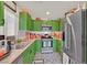 Stylish kitchen features vibrant green cabinetry and stainless steel appliances at 8868 Intertwine, Las Vegas, NV 89149