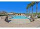 Outdoor pool featuring sun loungers, palm trees and a building in the background under a clear sky at 8868 Intertwine, Las Vegas, NV 89149