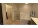 Bright bathroom includes a bathtub, shower and tile floors with access to closet at 9126 Haddington Ln, Las Vegas, NV 89145