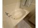 Relaxing bathtub with chrome fixtures and neutral tile surround at 9126 Haddington Ln, Las Vegas, NV 89145