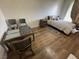 The bedroom features wood floors, accent furniture, and ample space at 9126 Haddington Ln, Las Vegas, NV 89145