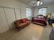 Bright bedroom featuring tile flooring, a ceiling fan and an additional couch at 9126 Haddington Ln, Las Vegas, NV 89145