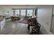 Comfortable living and dining area with tile flooring, neutral paint and mountain views from the multiple windows at 9126 Haddington Ln, Las Vegas, NV 89145