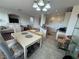 Well-lit living room with dining area, kitchen, and tile flooring at 9126 Haddington Ln, Las Vegas, NV 89145