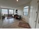 Cozy living room featuring tile flooring and abundant light from the large windows, plus mountain views at 9126 Haddington Ln, Las Vegas, NV 89145