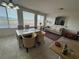 Open-concept living room with dining area, large windows, and a TV at 9126 Haddington Ln, Las Vegas, NV 89145