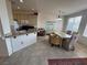 Cozy living and dining area featuring tile flooring, abundant light, and a functional kitchen at 9126 Haddington Ln, Las Vegas, NV 89145