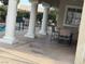 A covered patio area featuring stylish chairs provides shade and comfortable seating for guests at 9126 Haddington Ln, Las Vegas, NV 89145
