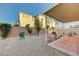 Backyard featuring desert landscaping, brick accents, a covered patio, and a fence at 980 Aspen Cliff Dr, Henderson, NV 89011