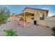 Backyard featuring desert landscaping, brick accents, a covered patio, and a fence at 980 Aspen Cliff Dr, Henderson, NV 89011