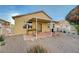 Backyard featuring desert landscaping, brick accents, a covered patio, and a fence at 980 Aspen Cliff Dr, Henderson, NV 89011